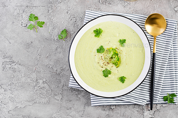 Homemade broccoli cream soup with croutons in white bowl on grey background. - Stock Photo - Images