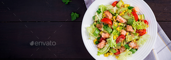 Salad with grilled salmon, lettuce, avocado, tomatoes and corn on a white bowl. - Stock Photo - Images