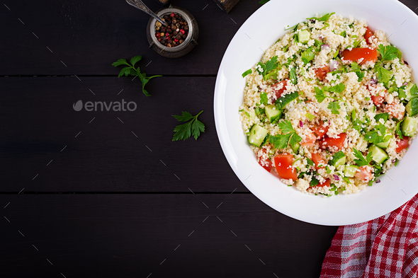 Traditional Lebanese Salad Tabbouleh. Couscous with parsley, tomato, cucumber - Stock Photo - Images