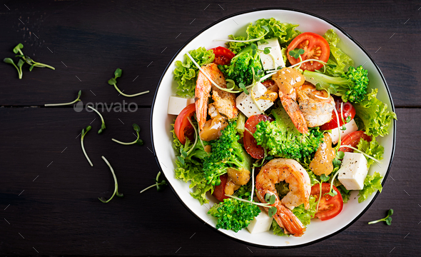 Delicious fresh salad with shrimps / prawns, broccoli, feta cheese, tomatoes - Stock Photo - Images