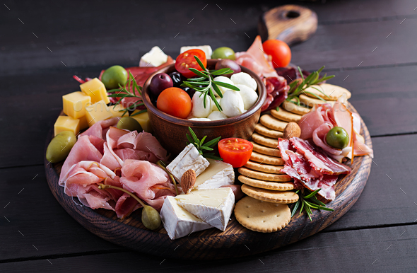 Antipasto platter with ham, prosciutto, salami, cheese, crackers and olives - Stock Photo - Images