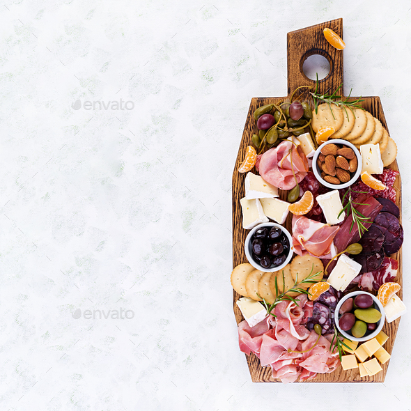 Antipasto platter with ham, prosciutto, salami, cheese, crackers and olives - Stock Photo - Images
