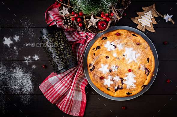 Christmas fruit cake, pudding on dark table. Top view, overhead, copy space.