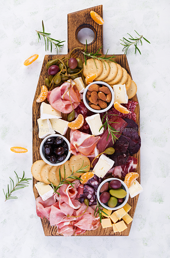 Antipasto platter with ham, prosciutto, salami, cheese, crackers and olives - Stock Photo - Images