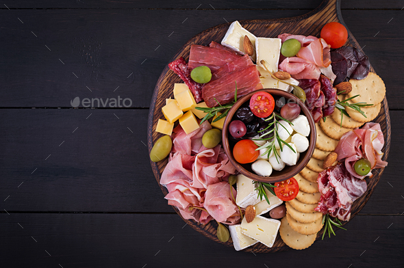 Antipasto platter with ham, prosciutto, salami, cheese, crackers and olives - Stock Photo - Images