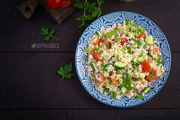 Traditional Lebanese Salad Tabbouleh. Couscous with parsley, tomato, cucumber, lemon - Stock Photo - Images