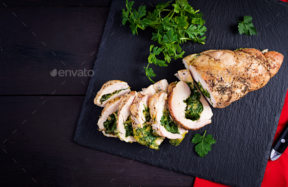 Roasted sliced Christmas roll of turkey with spinach and cheese - Stock Photo - Images