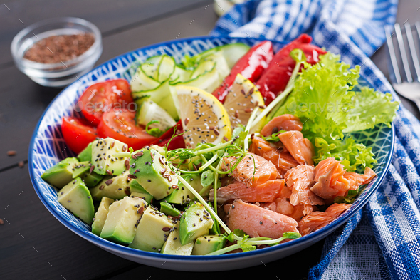 Healthy grilled salmon, avocado, tomato, cucumber, paprika and chia seeds. - Stock Photo - Images