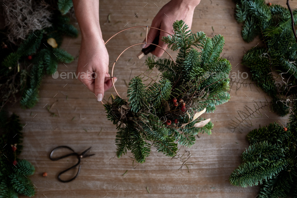 Woman making Christmas wreath of spruce, step by step. - Stock Photo - Images