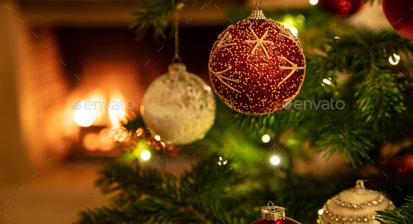 Christmas tree close up on burning fireplace background Stock Photo by rawf8