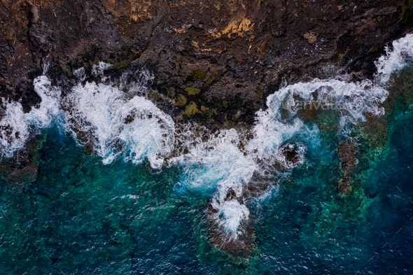 Rocky shore of the island of Tenerife. Aerial drone photo of ocean waves reaching shore - Stock Photo - Images