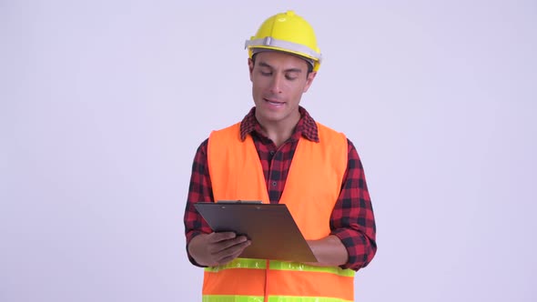 Young Happy Hispanic Man Construction Worker Showing Clipboard and Giving Thumbs Up