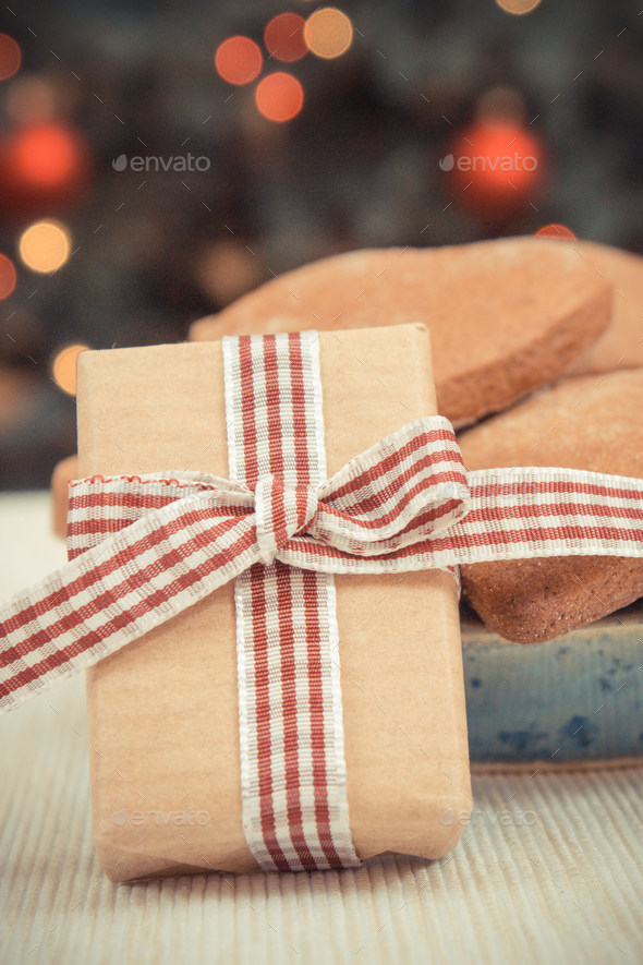 Wrapped gift, gingerbreads and christmas tree - Stock Photo - Images