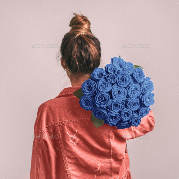 Back view of woman, holding Classic Blue roses - Stock Photo - Images