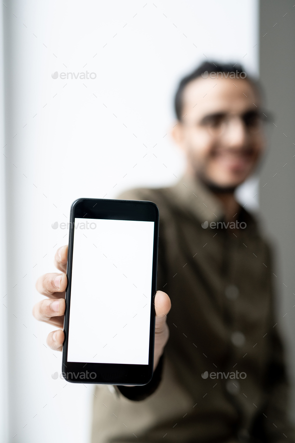 Smartphone with blank touchscreen in hand of young contemporary businessman - Stock Photo - Images