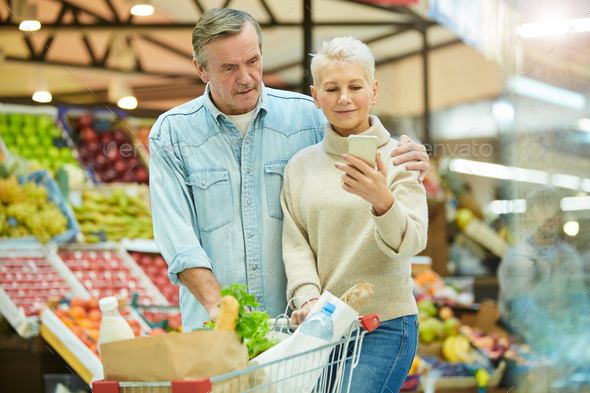 Modern Senior Couple Shopping in Supermarket - Stock Photo - Images