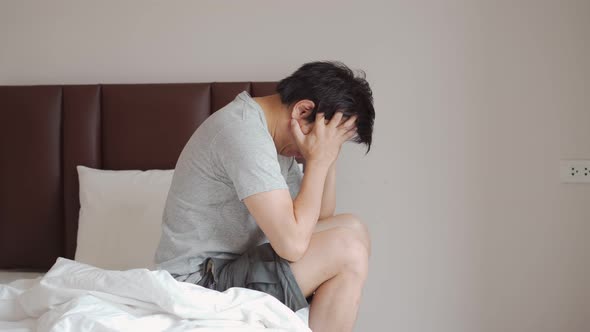 Lonely young man depressed and stressed sitting in the bedroom alt