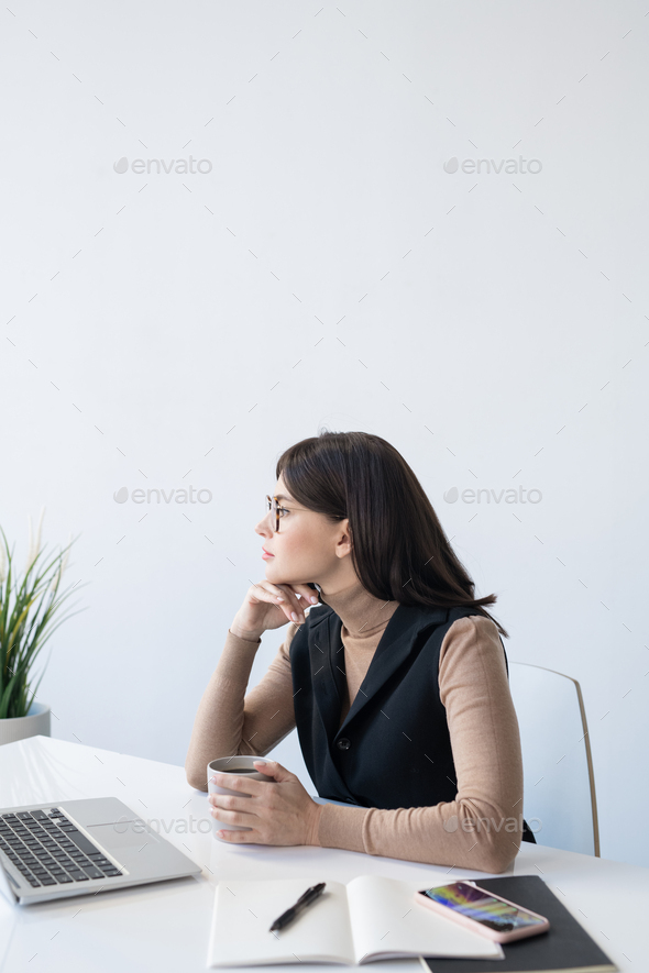 Pensive female analyst thinking of how to deal with financial situation