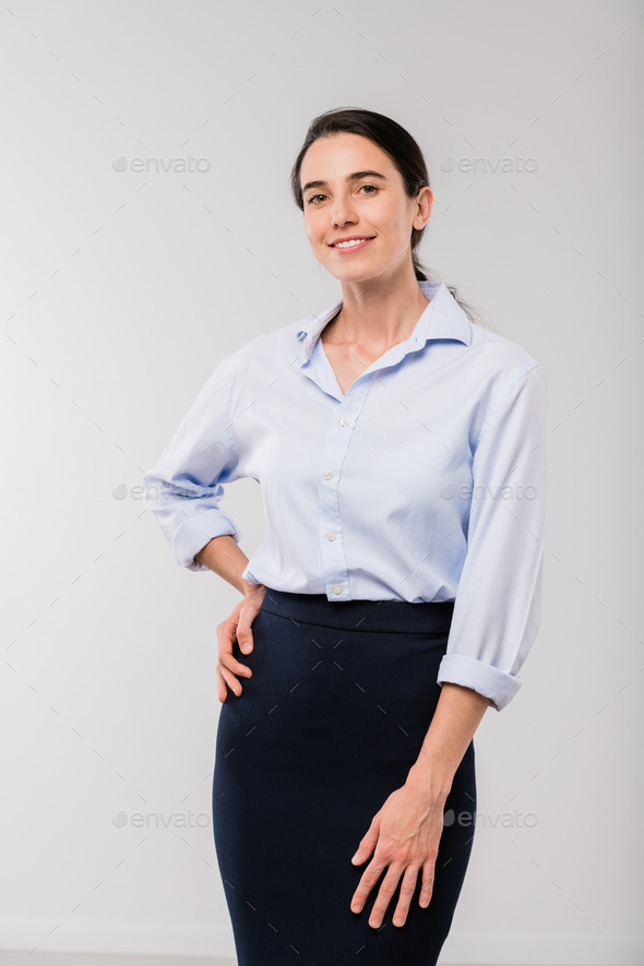 Happy young elegant businesswoman in white shirt looking at you in isolation - Stock Photo - Images