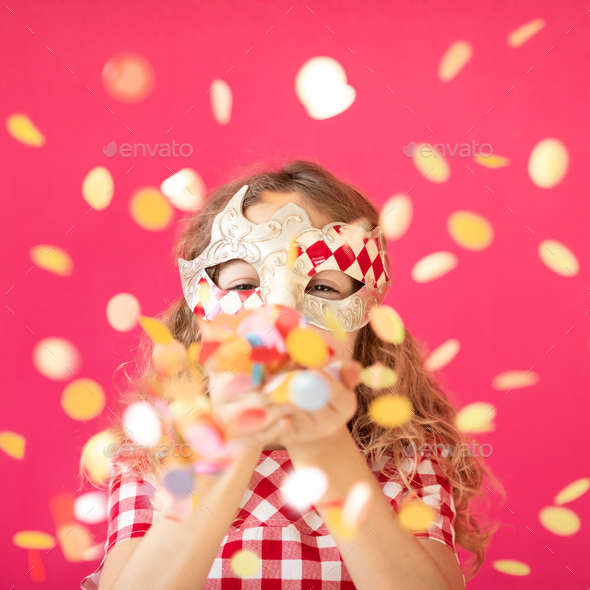 Fancy girl blowing confetti against pink bakground - Stock Photo - Images