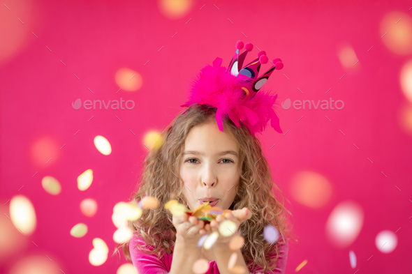 Fancy girl blowing confetti against pink bakground - Stock Photo - Images