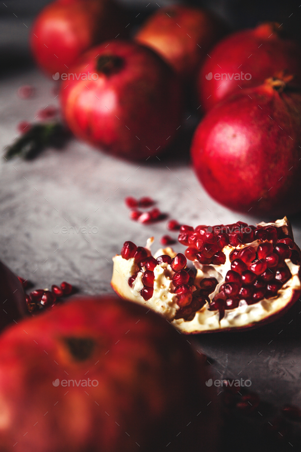 Pomegranate fruit. Ripe and juicy pomegranate on rustic grey background with copy space for text - Stock Photo - Images