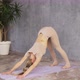 Attractive Caucasian Woman Practicing Yoga Standing in Adho Mukha Svanasana or Downward Facing Dog - VideoHive Item for Sale