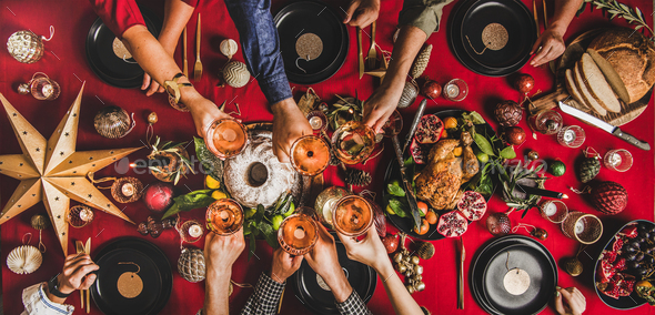Flat-lay of family celebrating and clinking glasses at Christmas - Stock Photo - Images