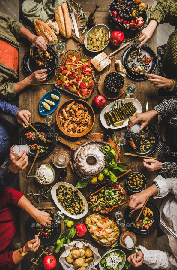 Turkish family feasting at table with traditional foods and raki - Stock Photo - Images