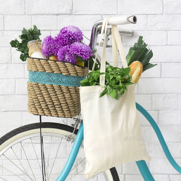Eco friendly retro bike decorated by violet wildflowers and shopping bag - Stock Photo - Images