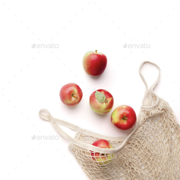 Fresh red apples in zero waste net bag on white background - Stock Photo - Images