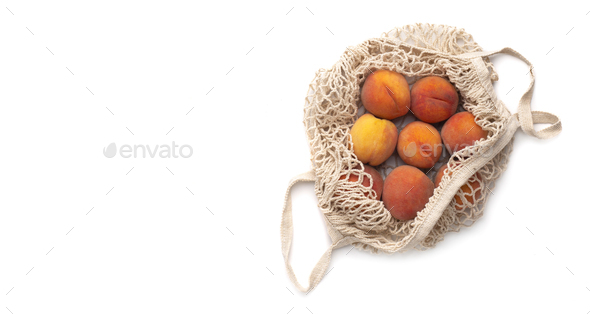 Juicy peaches full of vitamins in plastic free net bag isolated on white - Stock Photo - Images