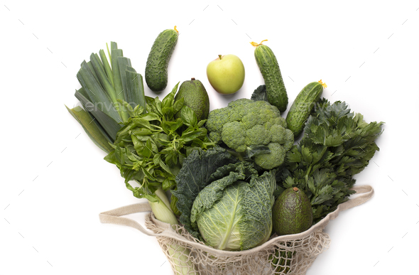 Green bunch of fruits and vegetables inside vintage mesh bag - Stock Photo - Images