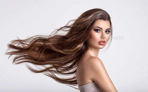 Portrait of a beautiful woman with a long hair. Stock Photo by valuavitaly
