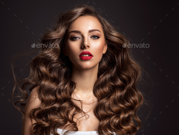 Beautiful woman with long brown hair and red lipstick. - Stock Photo - Images