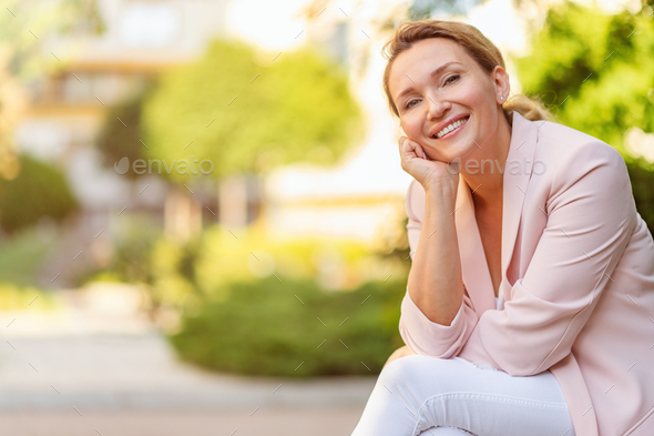 Close-up portrait of a smiling woman on the street. - Stock Photo - Images
