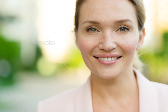 Close-up portrait of a smiling woman on the street. - Stock Photo - Images