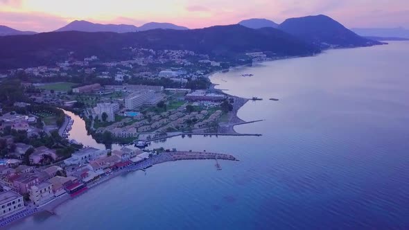 Greece, Corfu Island, drone footage of a beautiful sunset over Messonghi Beach. Camera Rise. alt