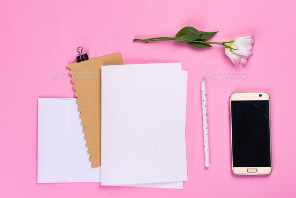 Flowers composition. Paper blank, phone and notebook with eustoma pink flowers on pink background - Stock Photo - Images