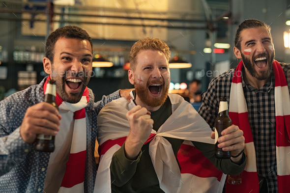 Friends cheering while supporting team - Stock Photo - Images