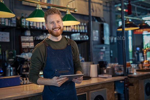 Smiling Waiter ready to take order at pub - Stock Photo - Images