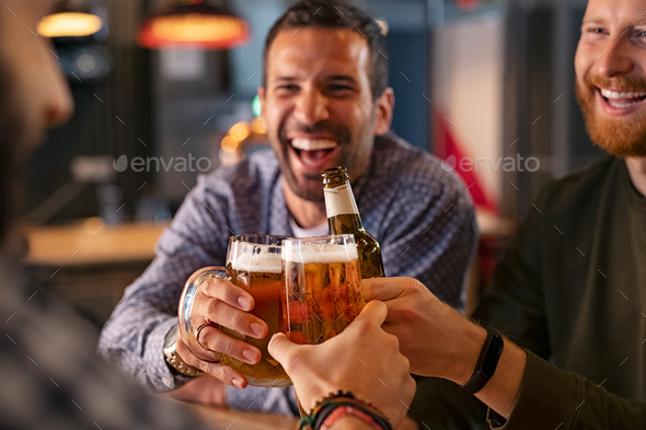 Friends toasting beer glass and bottle - Stock Photo - Images