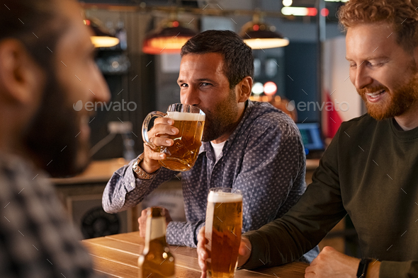 Man drinking draft beer with friends