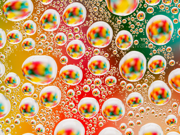 Abstract colorful vivid background with large and small spherical convex drops of water on the glass - Stock Photo - Images