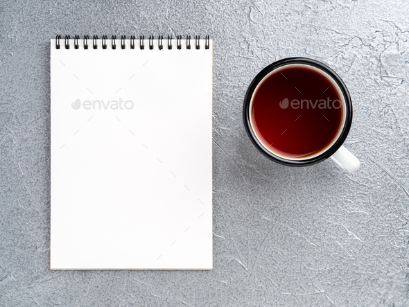 metal mug with tea, empty a blank sheet of Notepad on the spiral on a gray metallic background - Stock Photo - Images