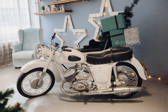 Cool retro motorcycle with Christmas presents. Motorcycle with gifts in decorated room - Stock Photo - Images