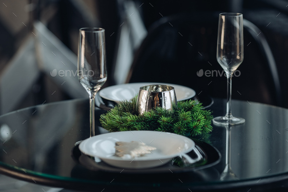 Romantic dinner for two at Christmas. plates against classic sofa in modern apartment - Stock Photo - Images