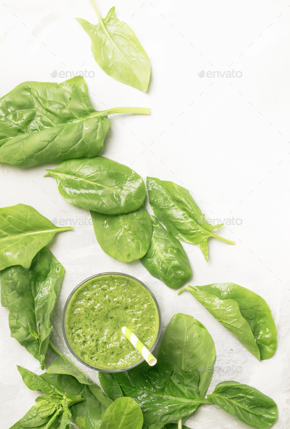 Spinach avocado smoothie and green leaves, drink background, healthy eating and raw diet - Stock Photo - Images