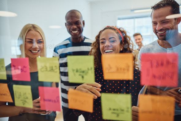 Laughing work colleagues brainstorming together in an office - Stock Photo - Images