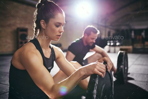 Two sportsmen having break after hard exercise - Stock Photo - Images